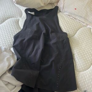 A black Lululemon tank top. NEVER worn size 0 very good to play tennis in